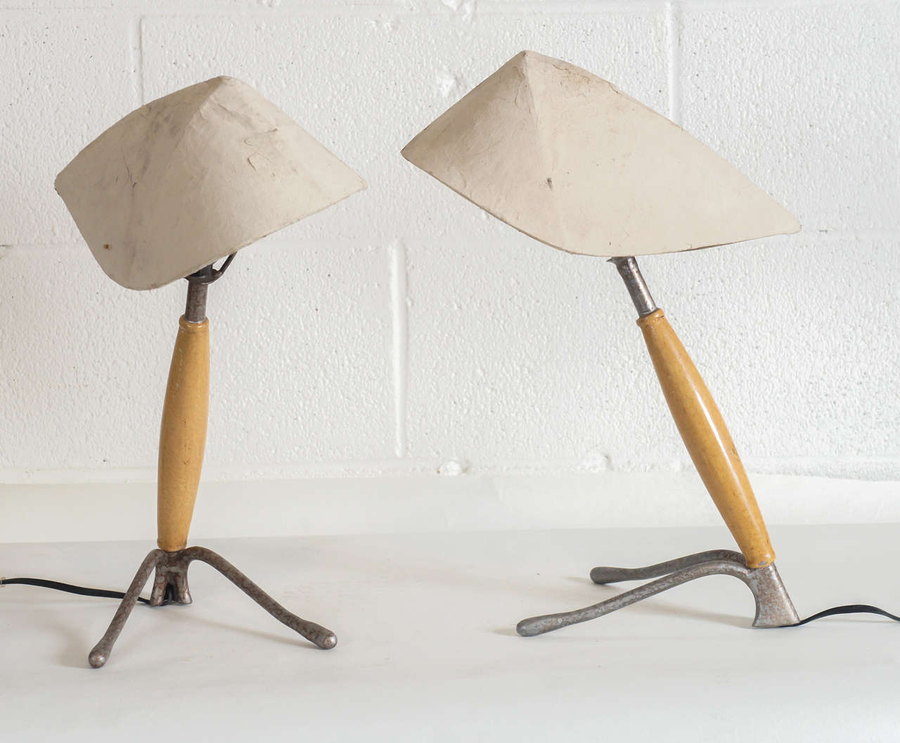 Here is a unique pair of lamps with papier mache shades.
The base is steel with a painted finish and has wood surround.