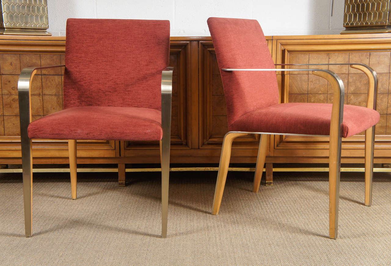 Here is a pair of armchairs with a sleek design in bent wood and steel.