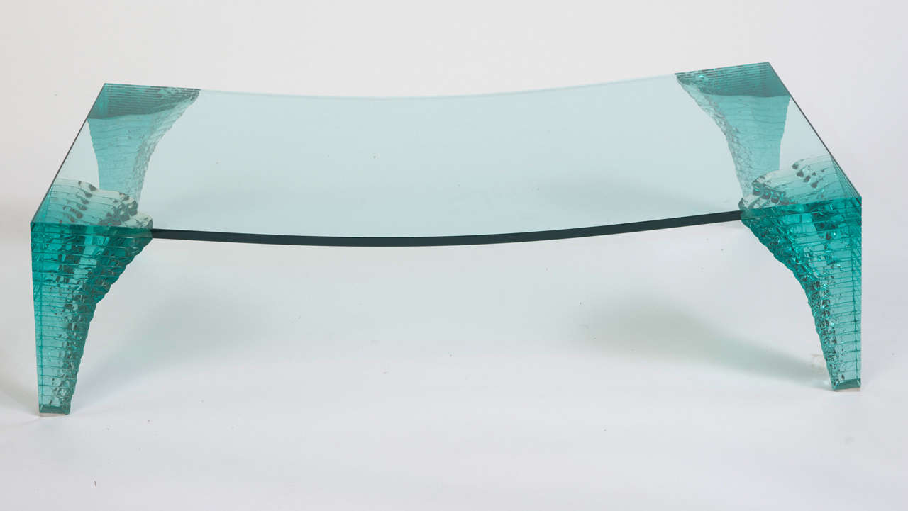 A Danny Lane “Atlas” coffee table.
A clear blue piece of concave glass set on four graduating stacked glass legs.
Designed by Danny Lane for Fiam.
Italy,
circa 1980.
Measures: 140cms W x 69cms D x 37.5 cms H.