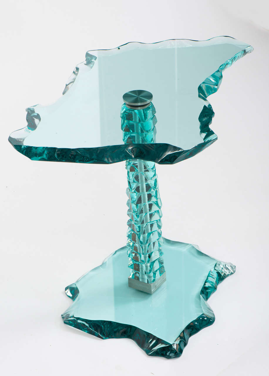 A small green tinted side Table by Danny Lane.

The top of fractured glass above a stacked glass base.

Signed and numbered 2827

England, 2014

65 cm w x 39 cm d x 49 cm h