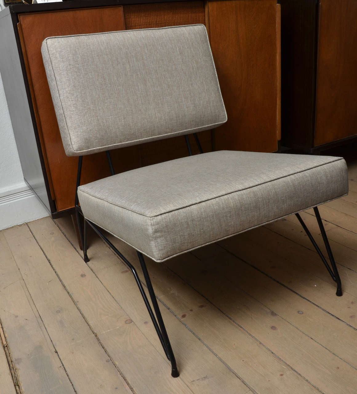 Stylish Italian design highlight this pair of iron base linen upholstered modernist chairs.