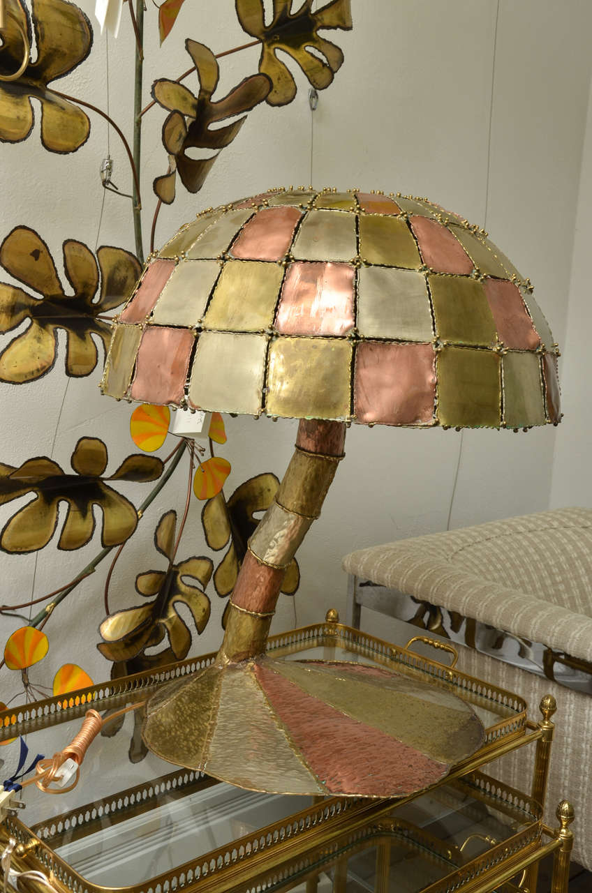 Single mushroom form table lamp composed of hammer mixed metal arranged in a patchwork motif.