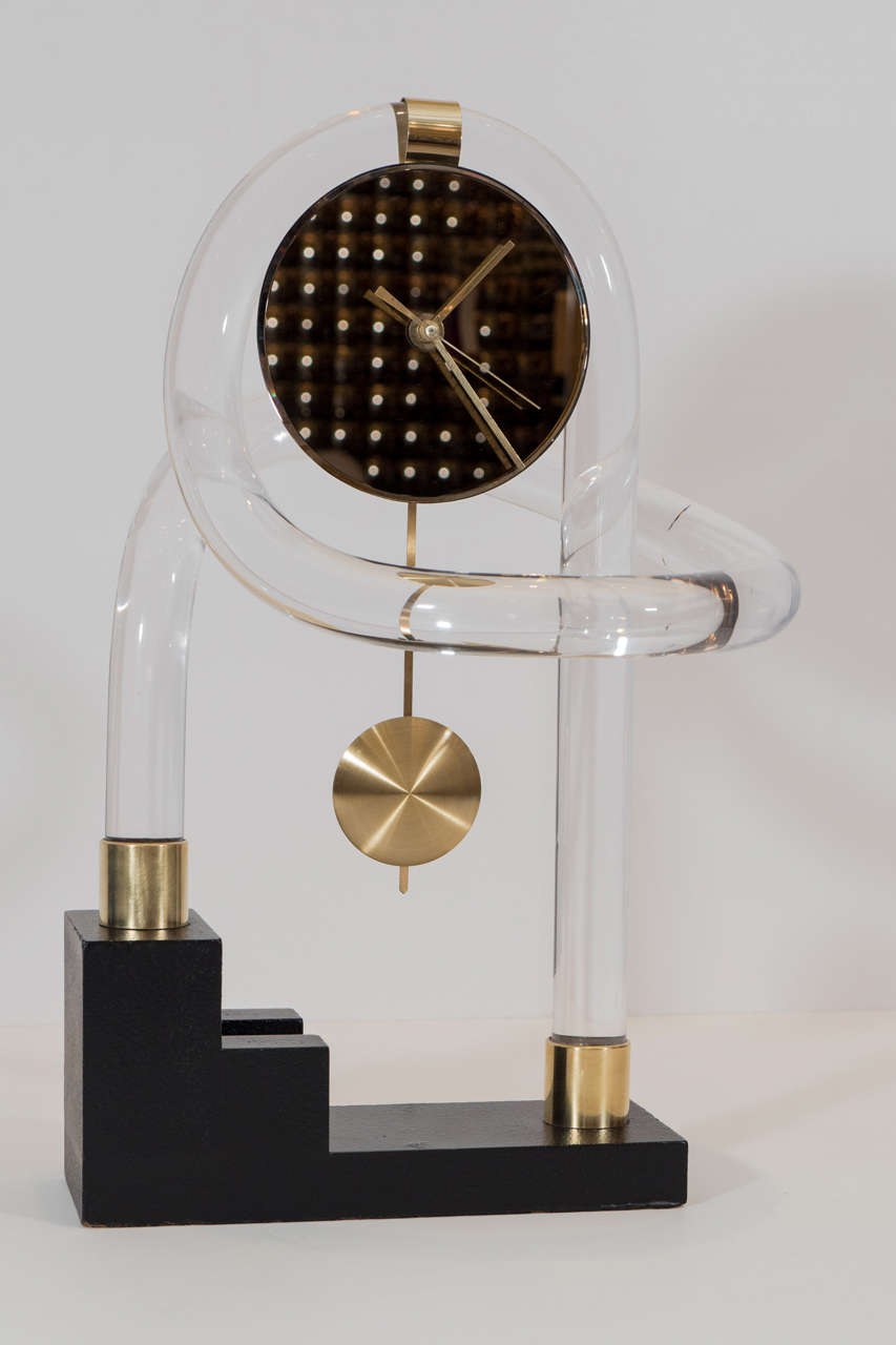 Playful 1980s period clock in a post modern design with lucite armature, bronze mirrored face and brass accents. Please contact for location.