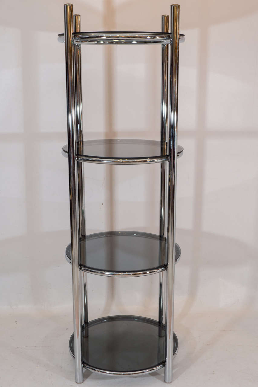 Handsome circular tower etagere with a chrome armature and gray glass shelves. Please contact for location.