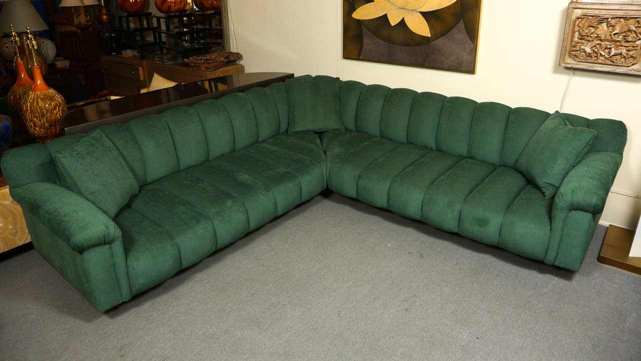 Beautiful two piece corner sectional sofa by Steve Chase.  The sofa has Chase's signature big channels, and is newly reupholstered in a lovely soft green chenille.  Three matching throw pillows are included.
Measurements below are for one section. 