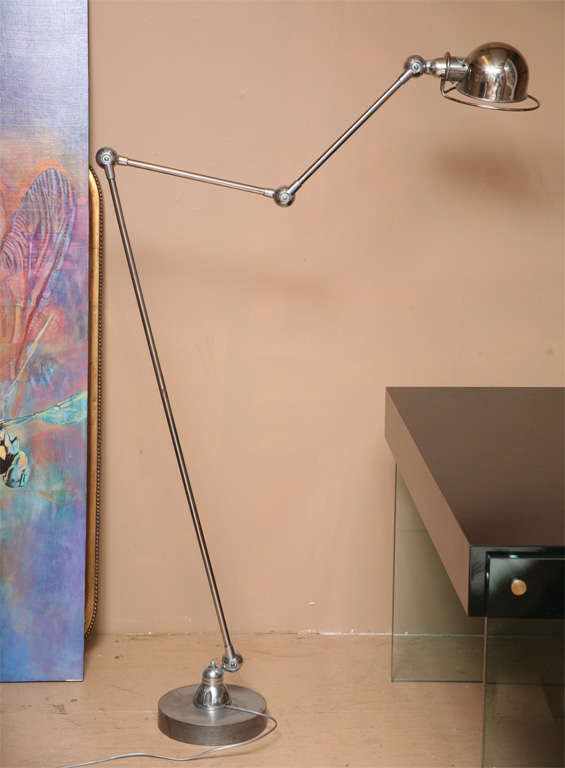 Articulated Industrial chrome lamp on steel base comes with its own wrench tool to adjust angles.