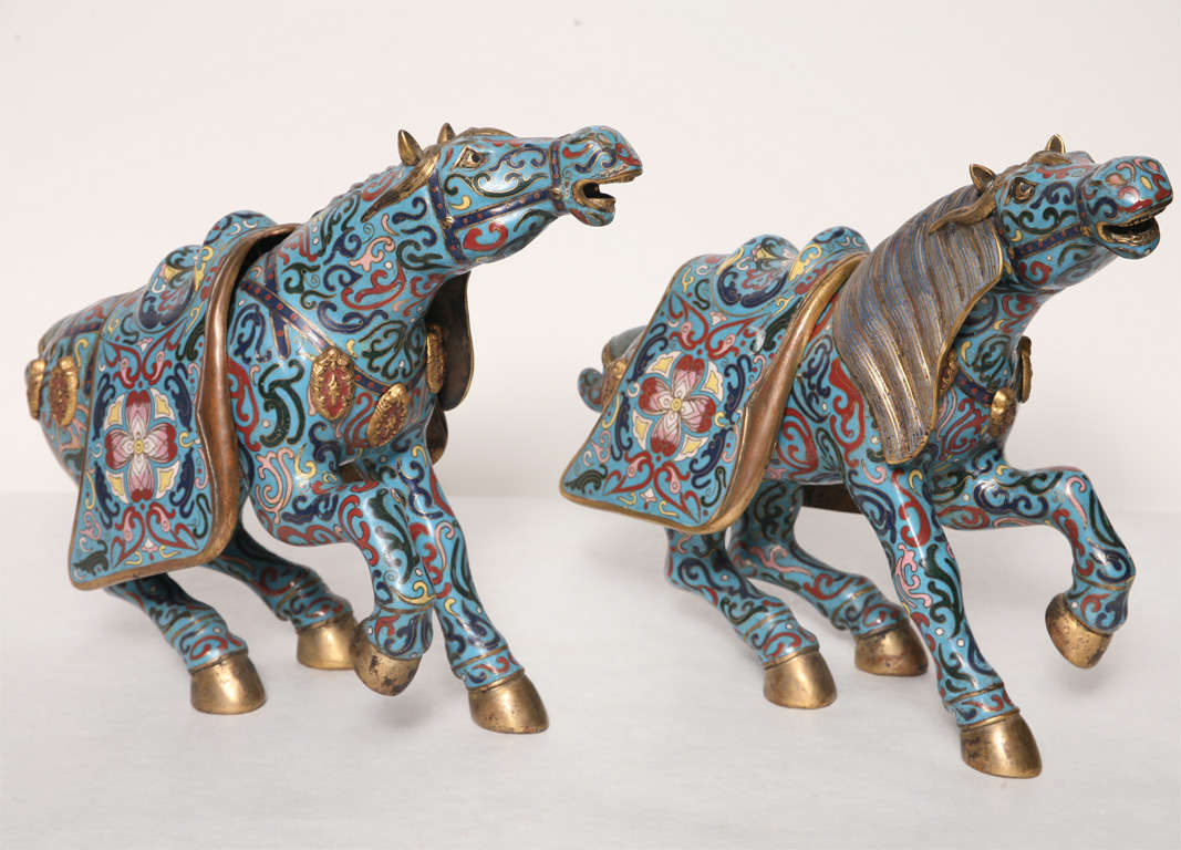 EACH FITTED WITH A REMOVABLE SADDLE, ENAMELLED IN VARIOUS COLORS HIGHLIGHTED WITH GILT ON A TURQUOISE GROUND, WITH GILDED MANE AND HOOVES.