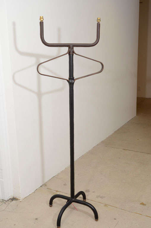 1950s double light floor lamp in stitched leather by Jacques Adnet.
Need to be rewired
Usually it's used with one large shade, but can be used with two shades also
No shade provided