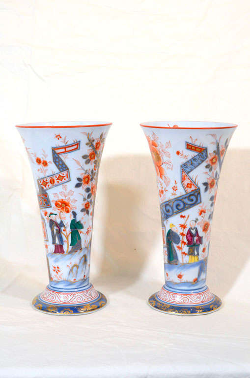 A pair of Bayeux trumpet shaped vases with Chinoiserie scenes painted in Imari colors with a stylish French touch of yellow, purple, and green.
The vases show a romantic Western vision of springtime using many of the themes typical of Chinese