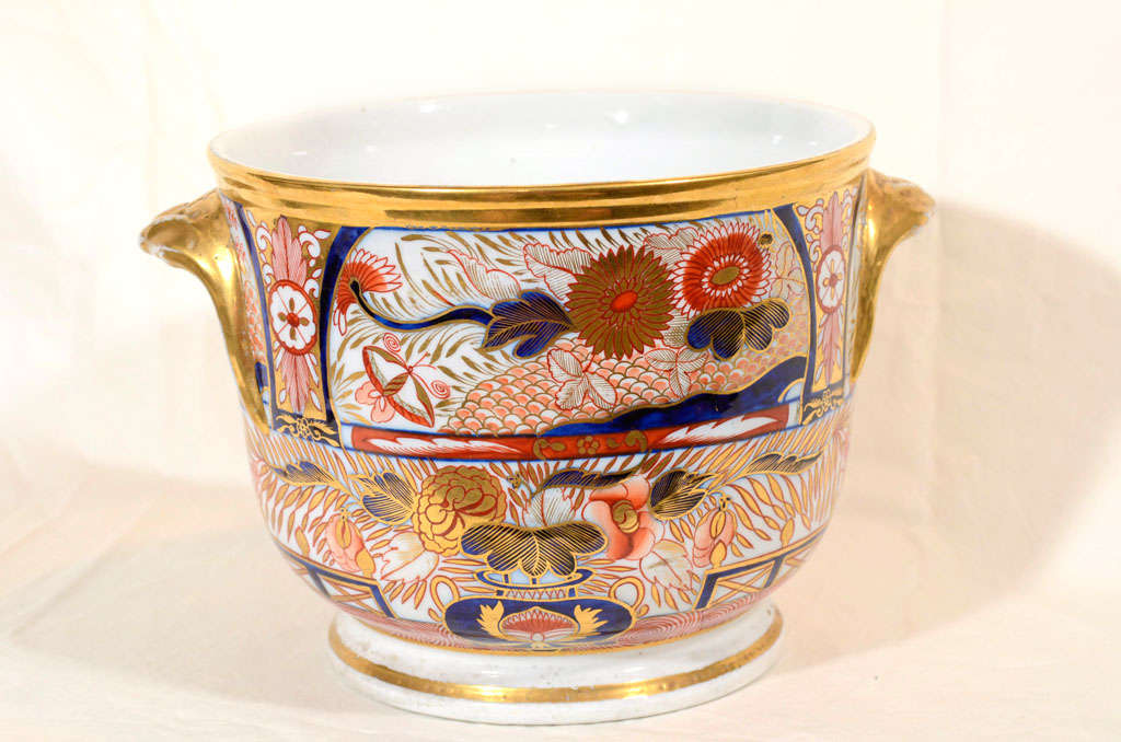 A pair of wine coolers in the richly gilded Coalport 