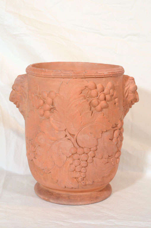 A pair of early 19th century Davenport terracotta wine coolers with impressed grapes and mask handles.