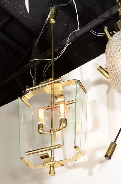 Italian Art Deco lantern with cast brass parts, two lights and four rounded edge glass panels, circa 1930. Each glass plate supported by a top and bottom rod allowing minimal framing to create an invisible and floating effect. Central rod supports