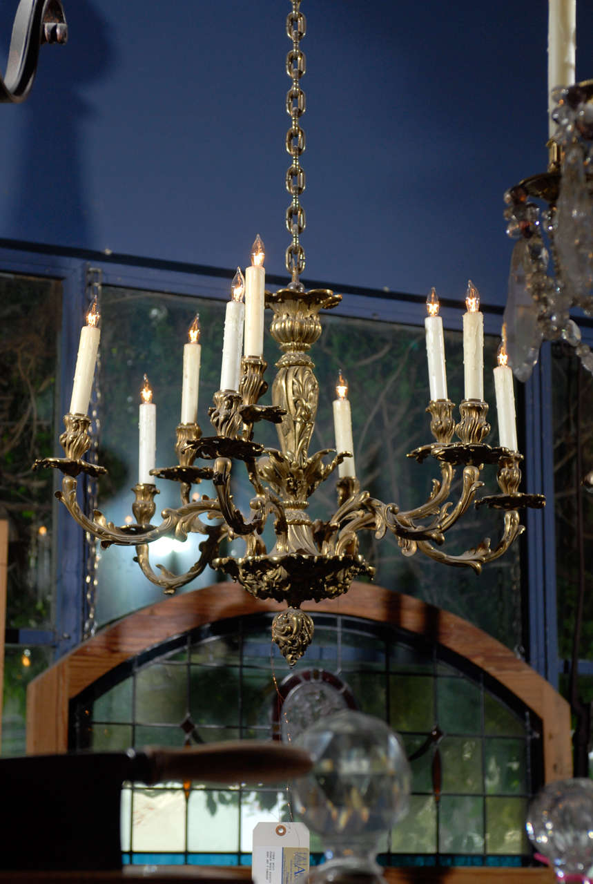 19th Century French Rococo style brass wired chandelier with 9 lights on 6 arms.  There are 3 double light arms on this fixture that alternate between 3 single light arms, which creates a lovely  balance on this chandelier.  Fine chased floral