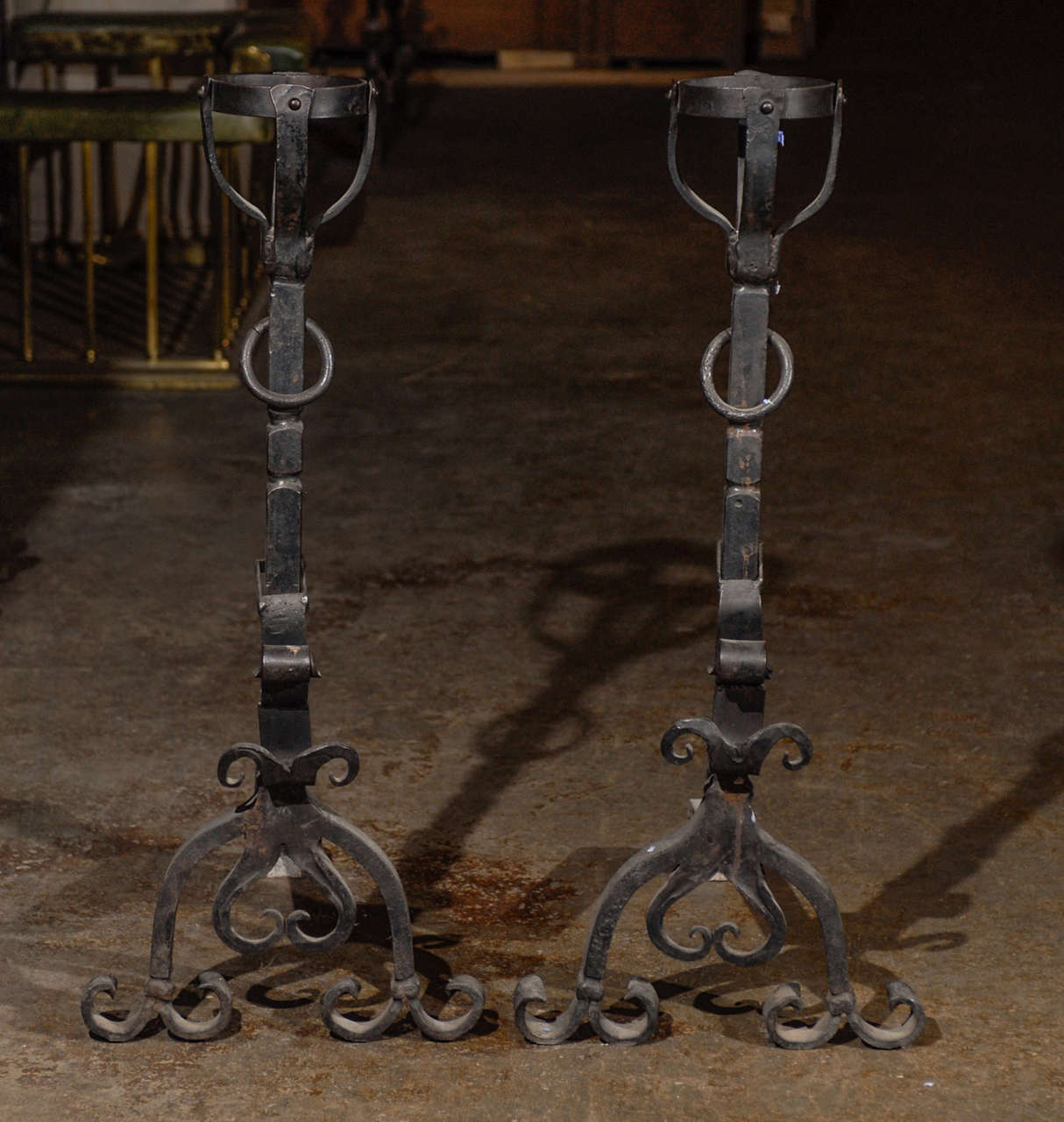 19th Century pair of large French Wrought Iron Landiers  that echo the bold arts & craft style.  The pair include baskets at the top and a ring that rotates within its keeper ,together with adjustable moustache rod brackets.