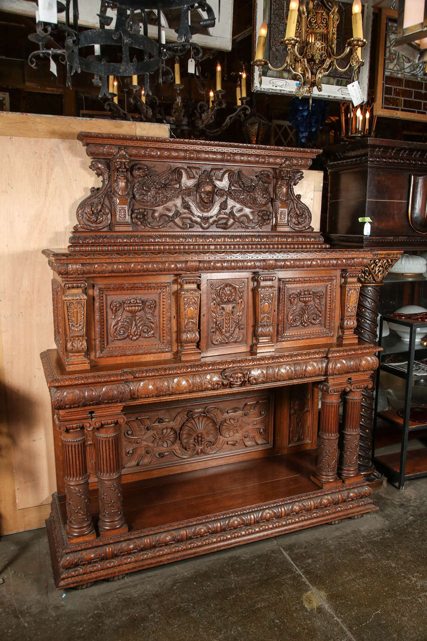 1890s Renaissance style hand carved tiger oak sideboard with four columns. Three cubbies. Centre one needs key. This can be seen at our 400 Gilligan St location in Scranton, PA.