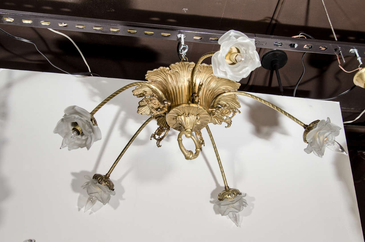 Fine bronze French Deco flush mount chandelier. The chandelier is comprised of a bronze dome in the form of acanthus leaves and features incised metal ornamention and designs throughout. The chandelier also feartures five reverse scrolled arms with