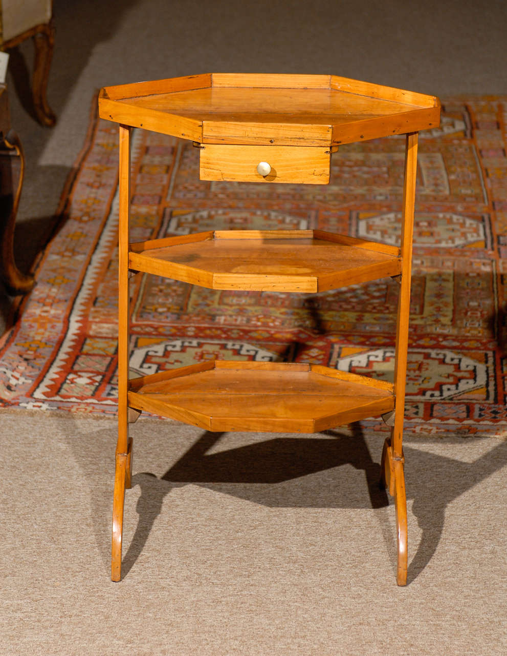 A Directoire fruitwood 3 tier work table in octagonal form with diamond inlay and drawer. 

William Word Fine Antiques: Atlanta's source for antique interiors since 1956.