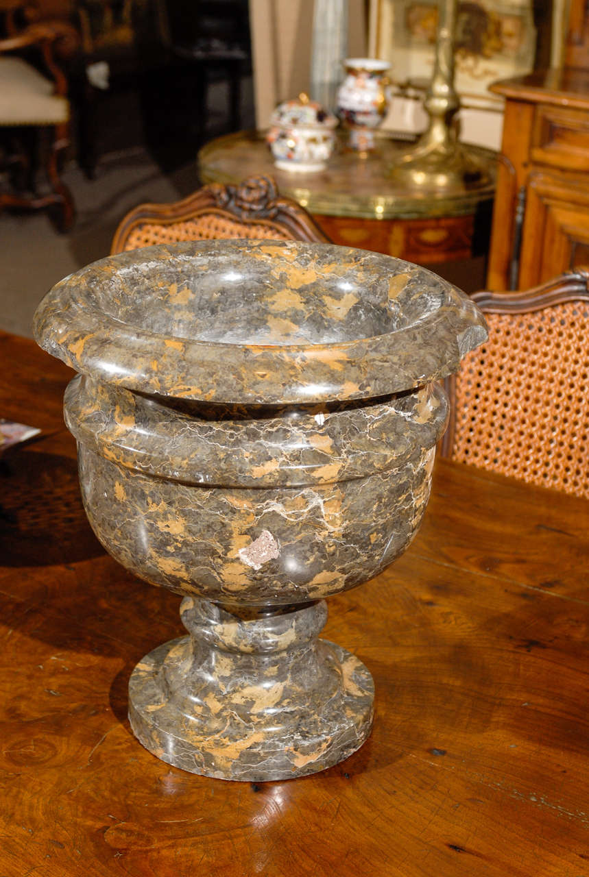 A Large mottled grey and tan marble urn