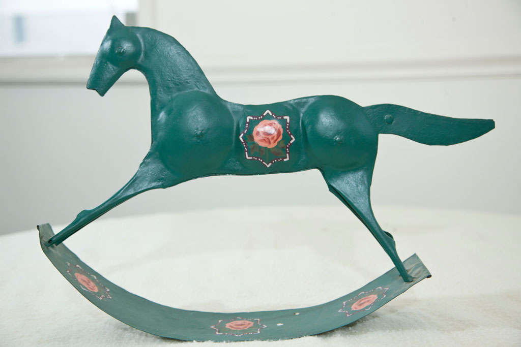 TIM PLATE HAND  MADE ROCKING HORSE TOY FROM MID 19TH CENTURY.  NEW ENGLAND. PAINTED GREEN WITH FOLK STYLE DECORATIONS