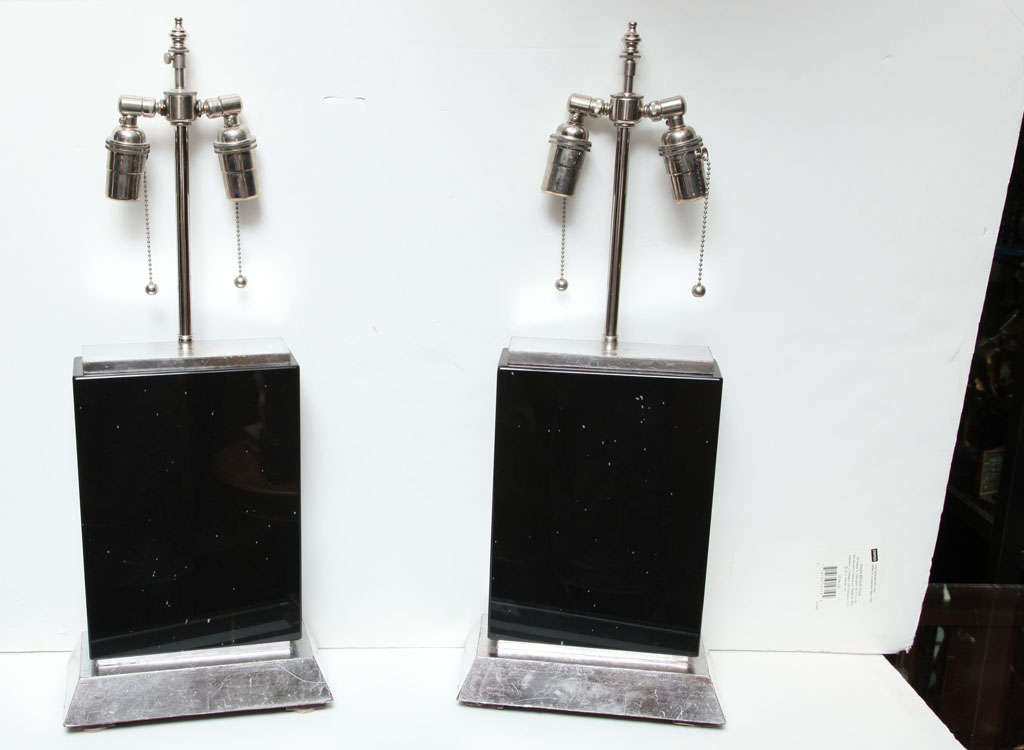 Pair of vintage table lamps in the Art Deco style crafted from rectangular black obsidian stone with silver gilt wooden bases and chromium plated lamp hardware.