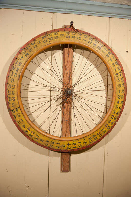 Roulette Gameing Wheel<br />
This Roulette wood rimmed bicycle wheel had been converted to a  double-sided Roulette wheel and used at Speakeasies during the Prohibition in America.  The color remains a vibrant yellow with deep red & black detailing