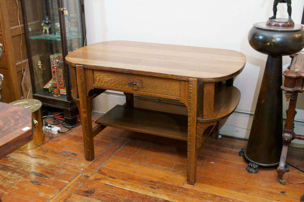 This handsome and chunky arts and crafts desk has the added feature of shelves on the side for books.  A very nice example of this period, with nice original hardware on the drawer.  A useful and reasonably priced desk.  It has been nicely