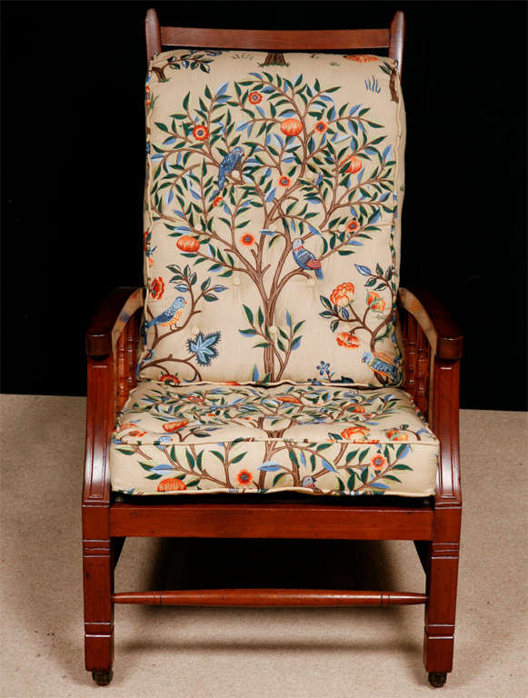 A Mahogany Arts and Crafts Armchair with adjustable back, known as the William Morris Chair
Original metal mounts and brass castors.
Ladder back . With turned supports beneath each bowed arm and raised on legs of square section united by