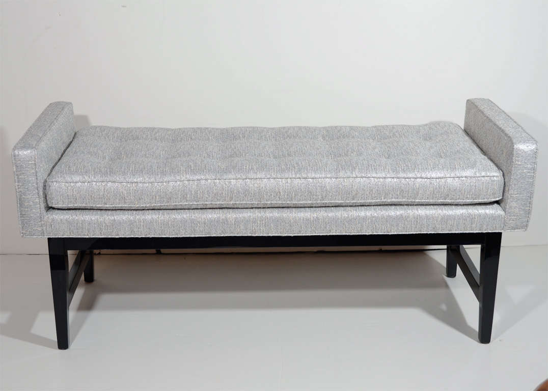 Elegant bench with modernist design newly upholstered
in grey and ivory metallic boucle with woven fibers in
platinum.  The bench has winged side design with button
seat deatails and ebonized walnut base and legs.