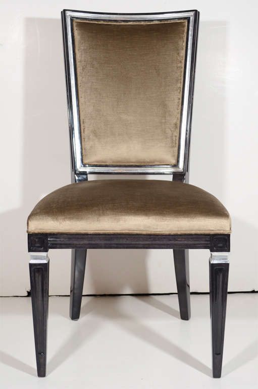 Pair of neoclassical style chairs with Gustavian design in walnut with an ebony finish and with antique silver leaf details. Chairs have an elegant high back design and have been upholstered in a mushroom tone crushed velvet. Perfect as occasional