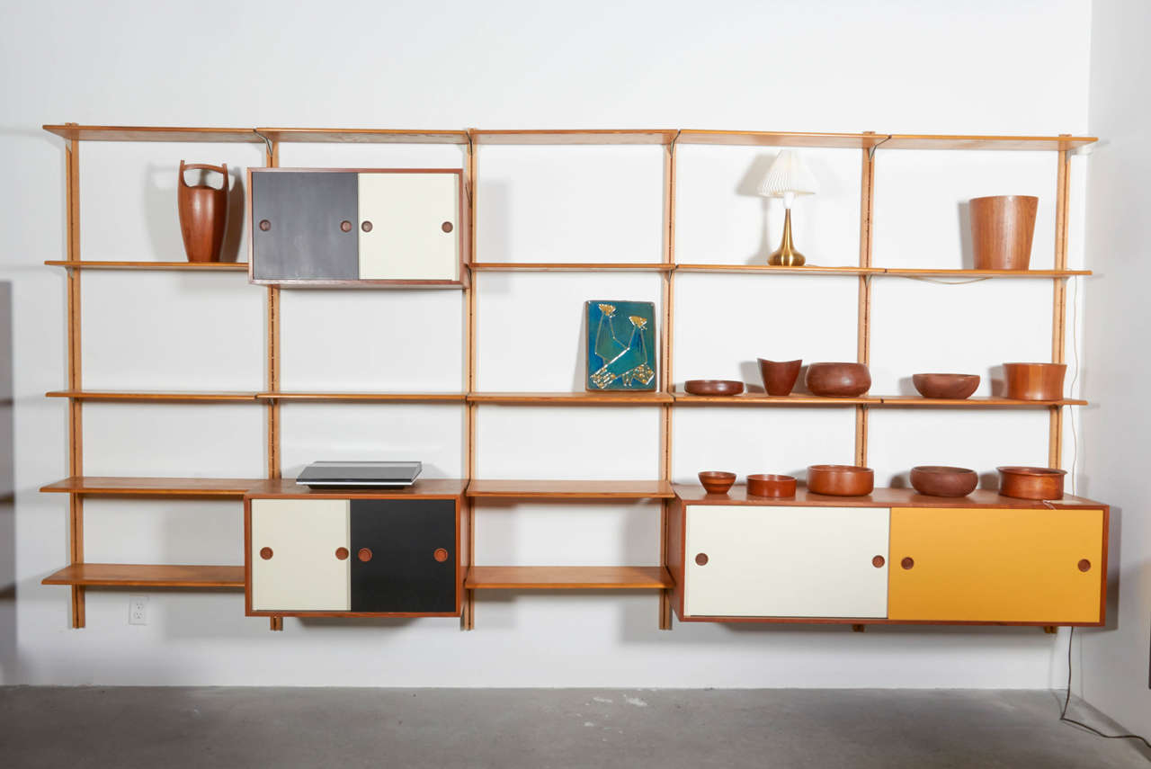Finn Juhl Panel Wall, Bovirke Denmark, 1953

This Teak Shelving Unit is extremely rare and in all original, beautiful condition. 21 oak shelves, three cabinets with painted doors, and 4 teak wall panels. This is a treasure, and something you will