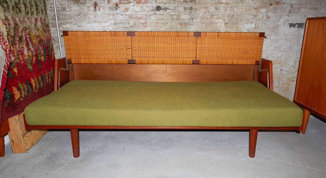 A versatile classic by Hans Wegner.  This example has a newly upholstered mattress and is perfectly functioning and sturdy.  The cane is quite nice.