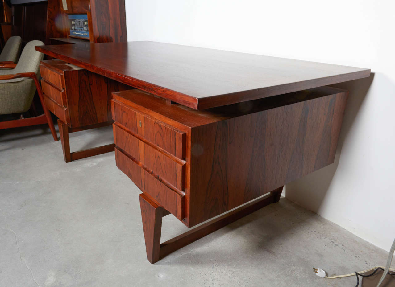 Vintage 1960s Danish Rosewood Desk by Illum Wikkelso

This rosewood desk is in like-new condition. Back has solid rosewood panel. Ready for pick up, delivery, or shipping. 