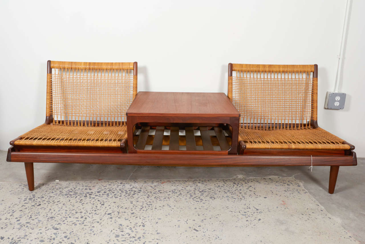 Here is a wonderful Mid Century Teak and Cane modular sofa designed by Hans Olsen of Denmark. The chairs and table can be rearranged or used directly on the floor.