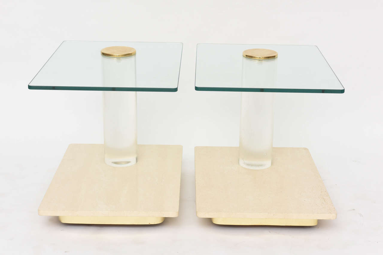 The cantilevered glass over a Lucite column with brass cap, all above a travertine amble base, on hidden wheels, these pieces were custom designed originally by Steven Frye, owner of Lion in Frost, for the Russian Embassy and have been vetted by him