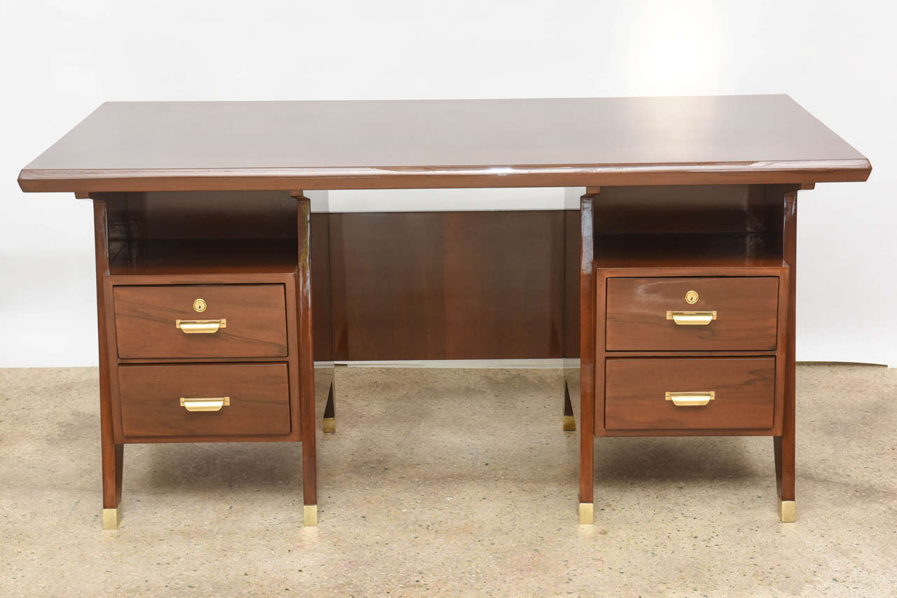 The rectangular top with rounded edges above drawer cabinets each with two drawers, flanking angled geometric legs terminating in brass sabots.
Comes with certificate of authenticity from Gio Ponti archives and foundation
hardware original to piece.