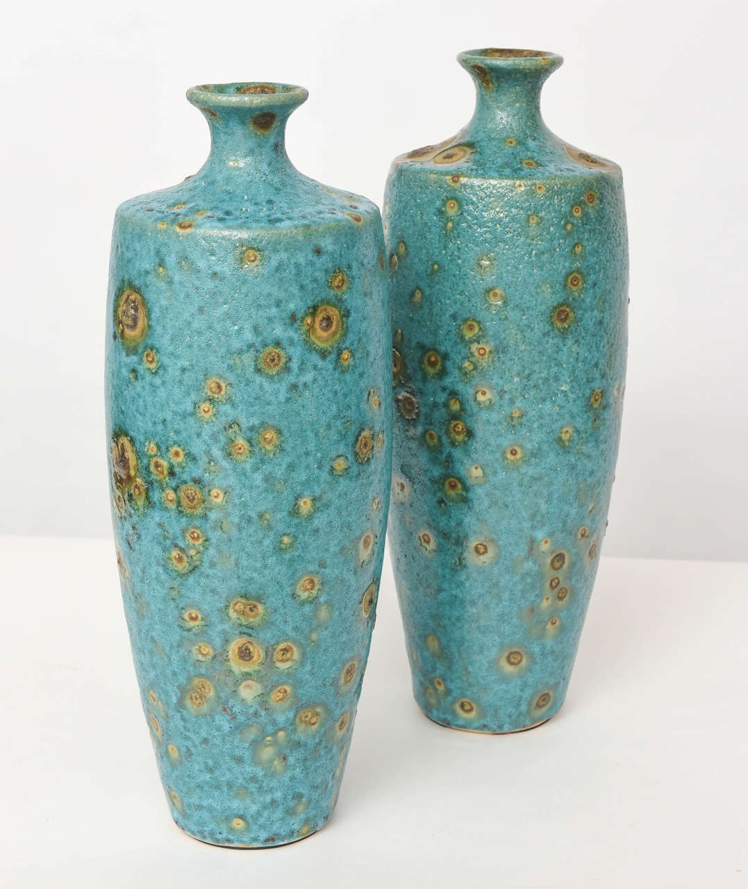 The glaze in turquoise and with golden bursts, all with a mottled finish.