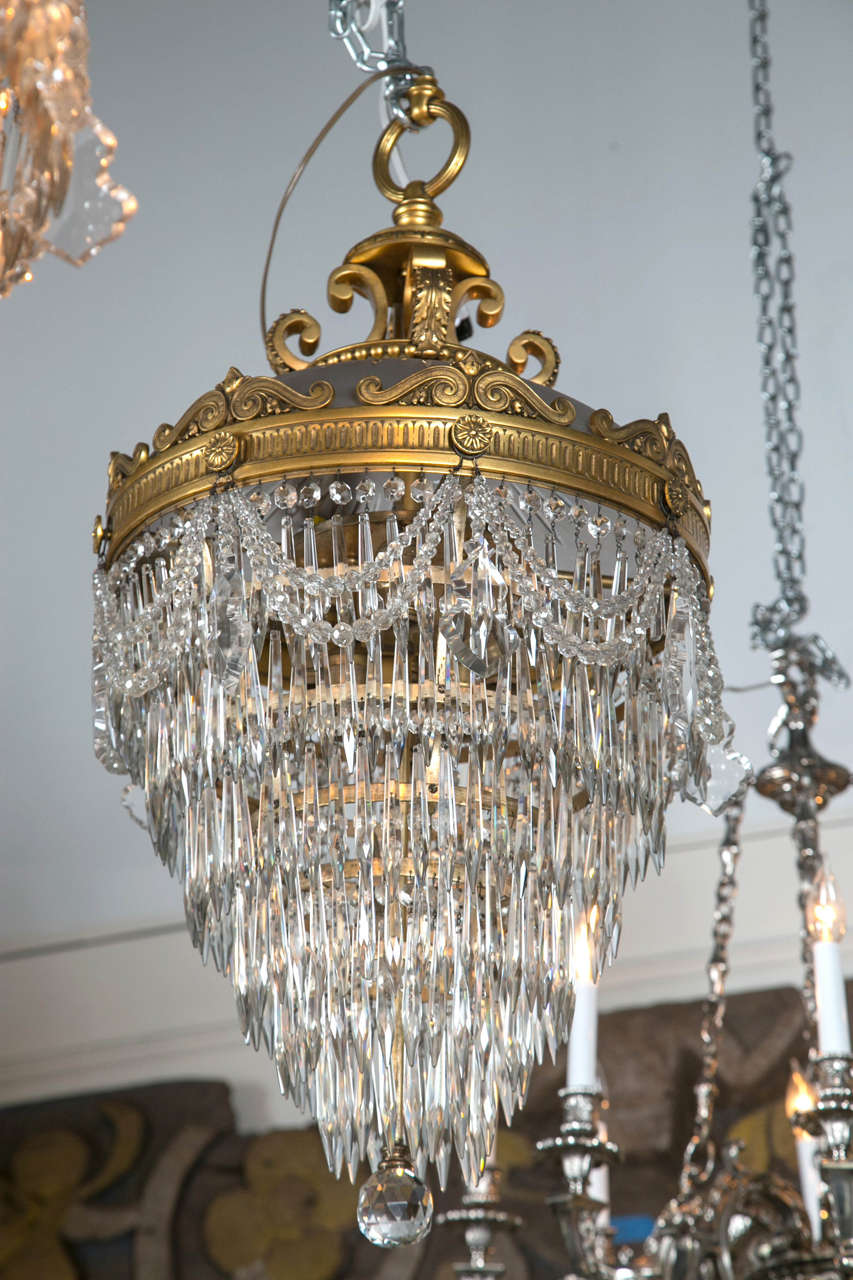 A pair of magnificent doré bronze and crystal drop six-tier 'wedding cake' chandeliers each having six lights. Most likely Caldwell.
Provenance: Carlin family, 3233 Euclid Ave., Cleveland, OH.