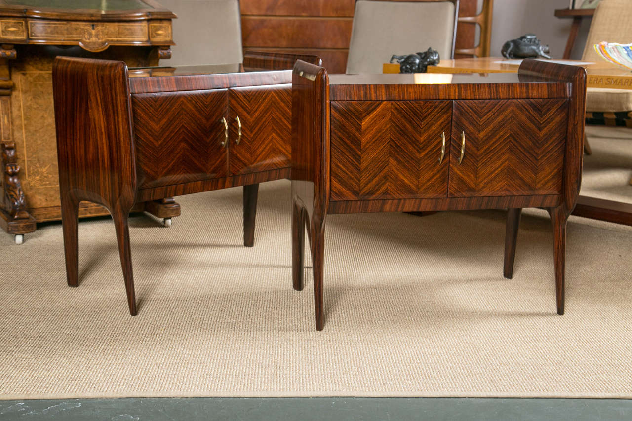 Paolo Buffa style pair of nightstands having rosewood Herring bone pattern veneer with brass hardware and antiqued mirrored-glass tops. Newly refinished. Italy Circa 1950's.
