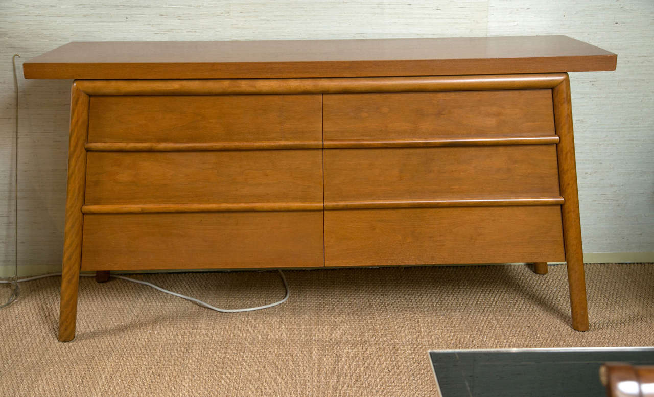 T.H. Robsjohn-Gibbings credenza bleached walnut six-drawer credenza with slab top and canted legs.