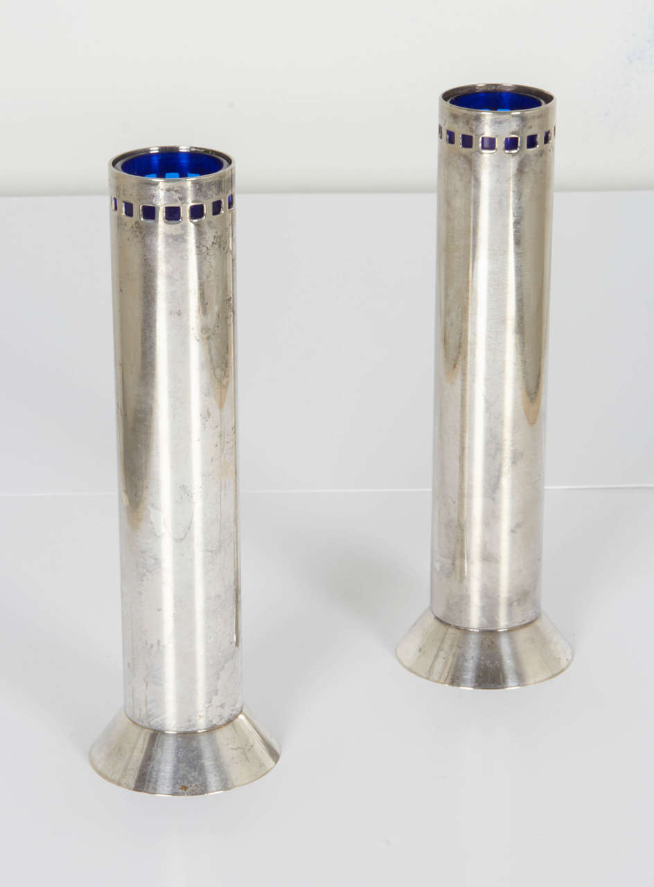 Pair of skyscraper bud vases by Richard Meier. Silver plate with blue glass inserts.