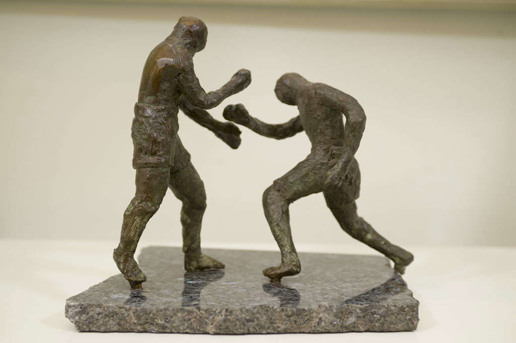 A dynamic pair of powerful bronze boxers mounted on granite. Unsigned.