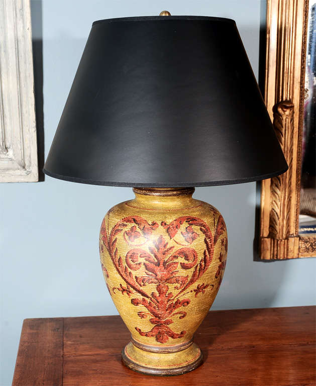 A decorative painted metal urn lamp.