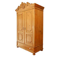 A Austrian Pine Armoire With Carved Bonnet