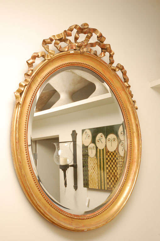 Oval Giltwood Mirror Crowned with Flowing Ribbon Detail Beaded Inner Border