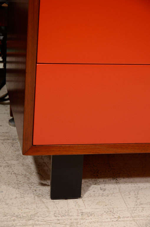 American George Nelson walnut dresser with red font and cupcake pulls