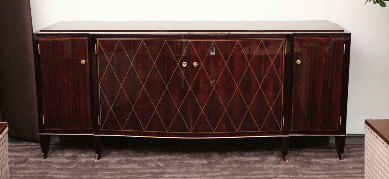 Brazilian rosewood sideboard signed by Albert Fournier et Co on inside of left middle door. Marquetry detailing on doors. Gold leaf and brass details and metal capped feet. Exceptional quality. Adjustable shelving inside. 
Set by Albert Fournier