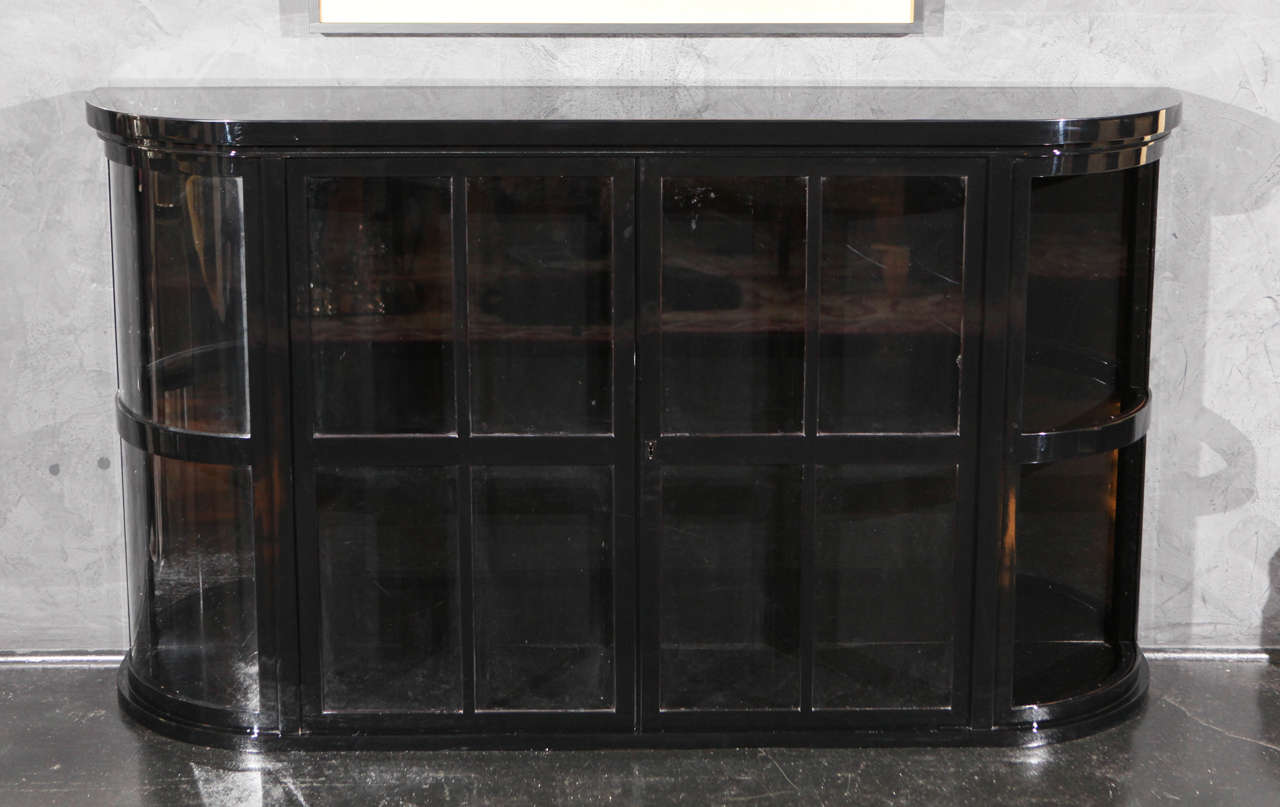 Two Level vitrine console in black lacquer. Glass front as well as glass shelving inside.