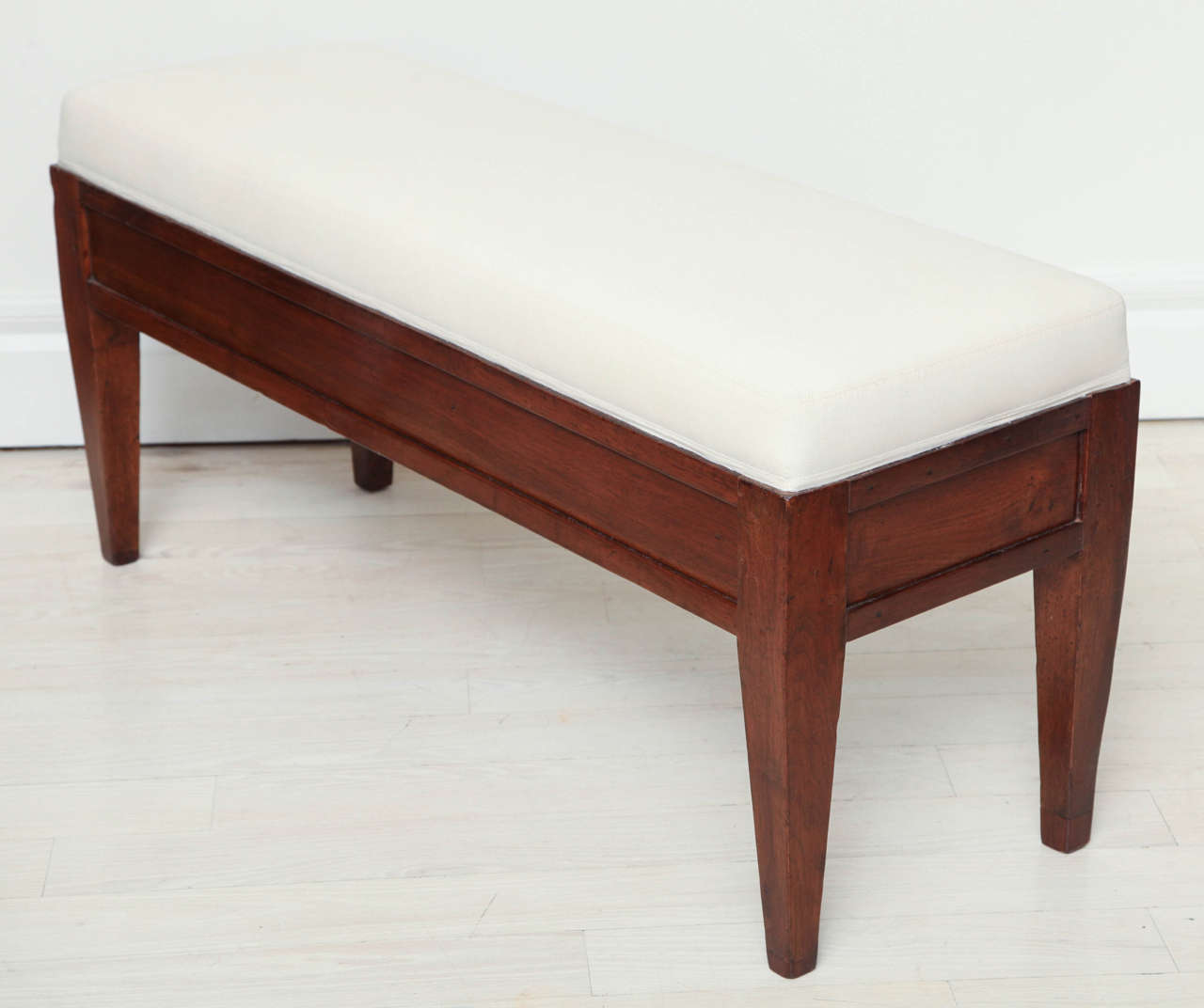 Pair of walnut hall benches, each with paneled front and sides on square tapered legs