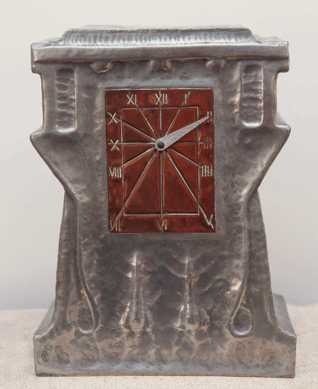 Liberty & Co. hand-wrought Tudric pewter clock with copper dial and roman numerals. Embossed on base, British, circa 1905

Original wind-up key included. Clock is in working condition.