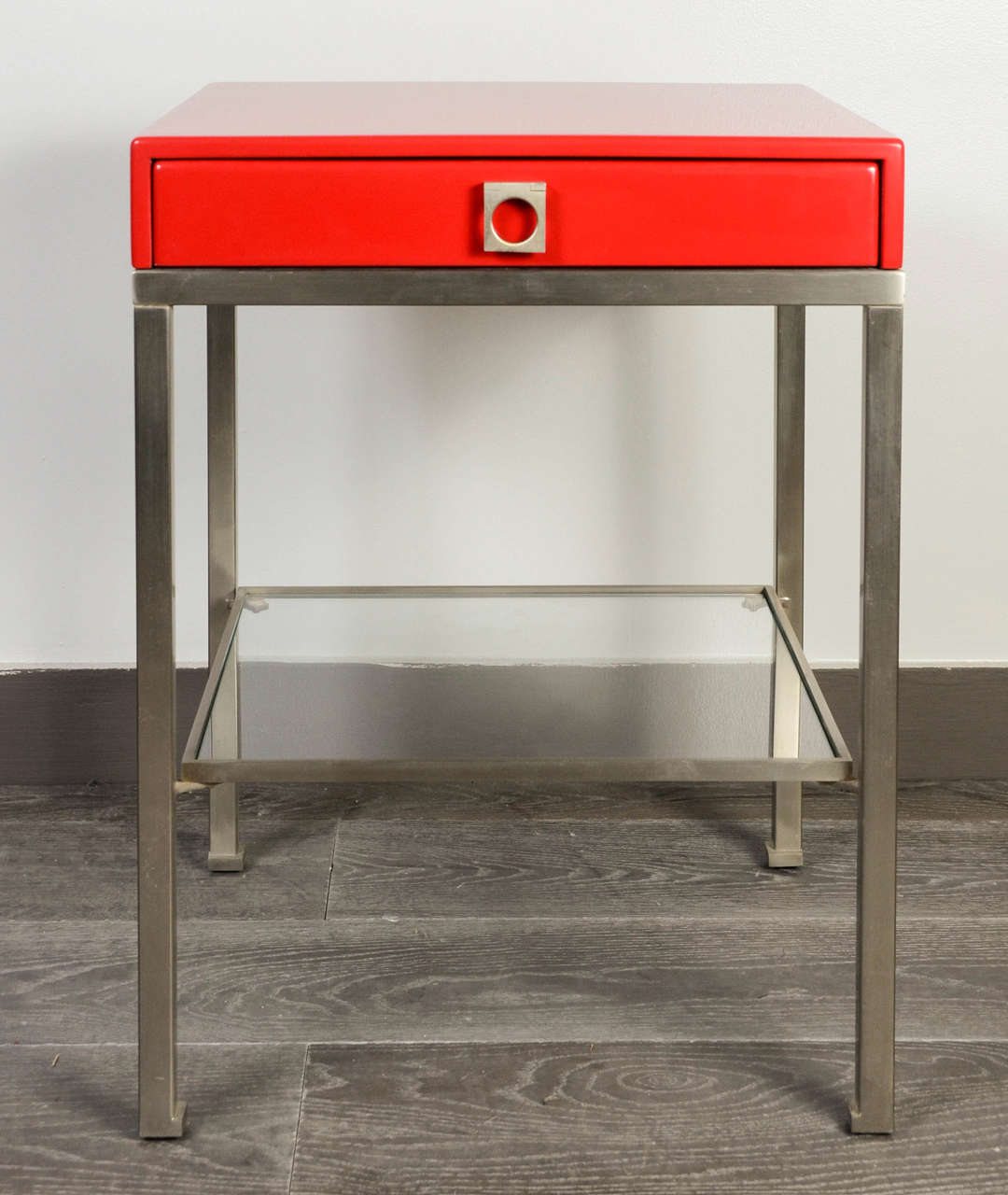 Elegant pair of side tables , base steel with a new red lacquer, glass shelf.<br />
By Guy Lefebvre.